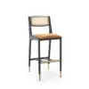 Black bar stool with woven back and brass legs.