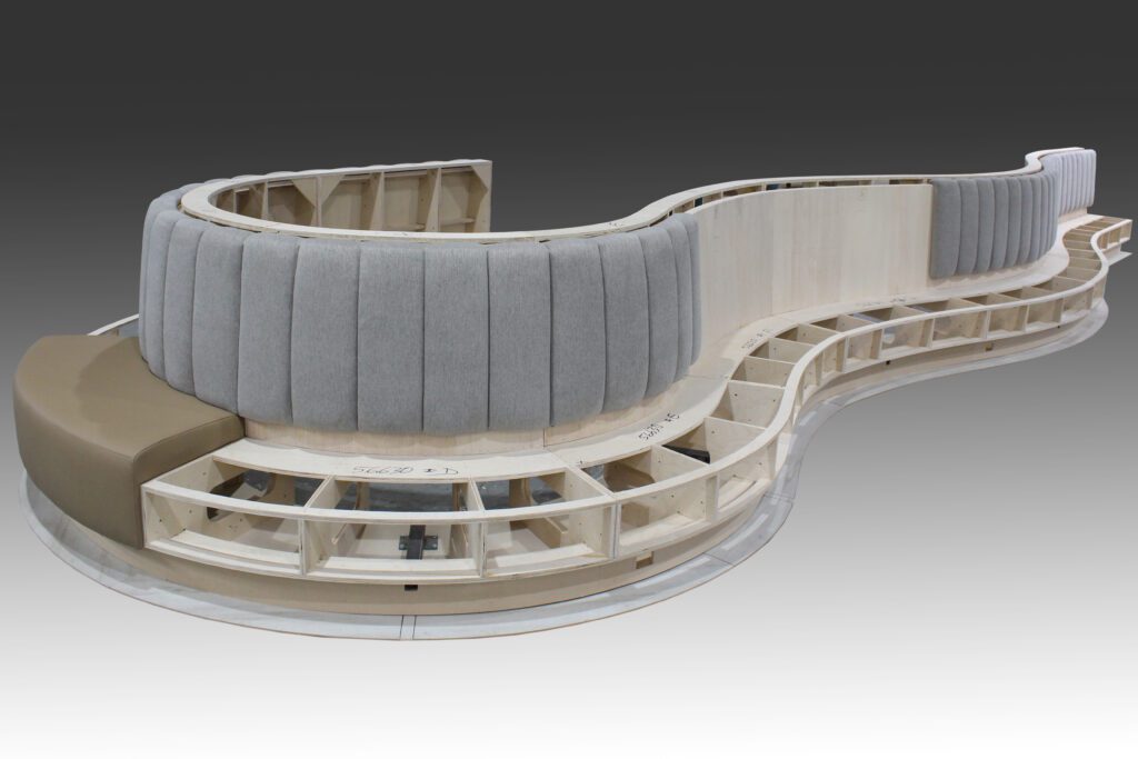 Curved modern bench with wood frame.