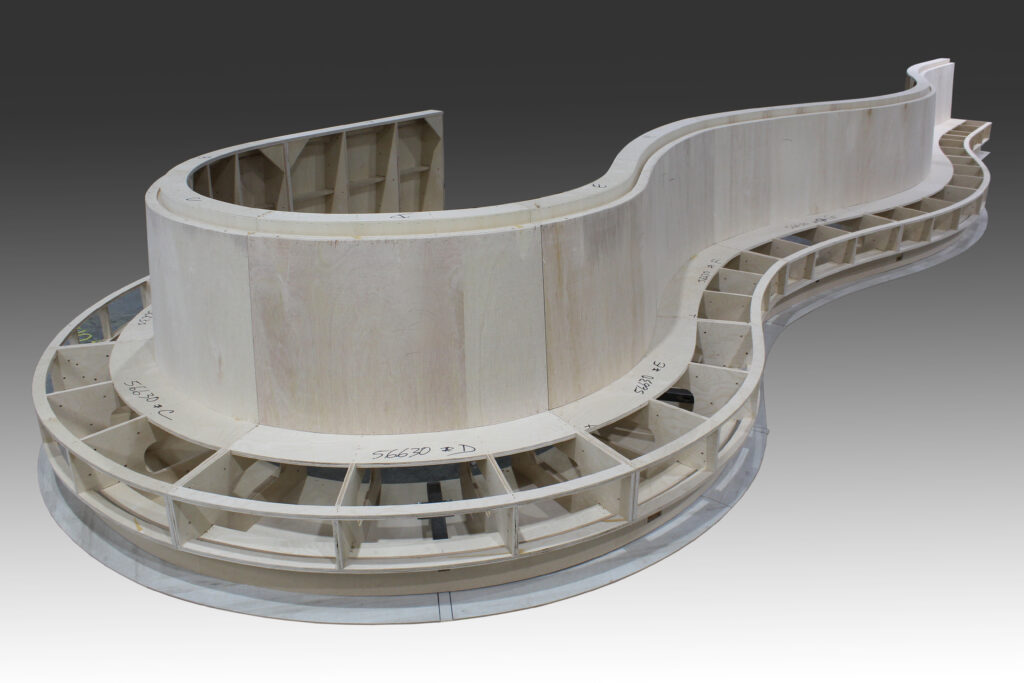 Wooden architectural model with curved structure.