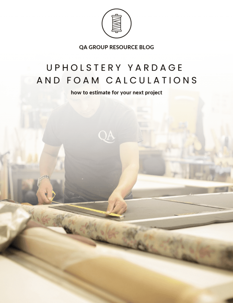 Person measuring fabric in upholstery workshop.